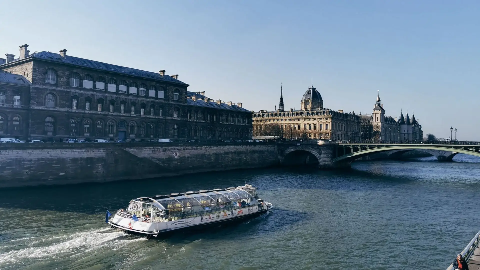 Glass-sided river boat on the Seine passing the Île de la Cité Glass-sided river boat on the Seine passing the Île de la Cité