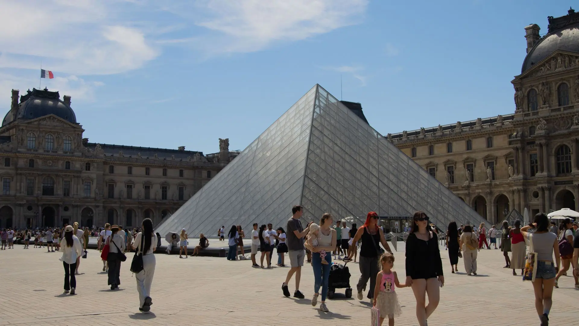 Visitors in the Cour Napoléon around the Louvre pyramid Visitors in the Cour Napoléon around the Louvre pyramid