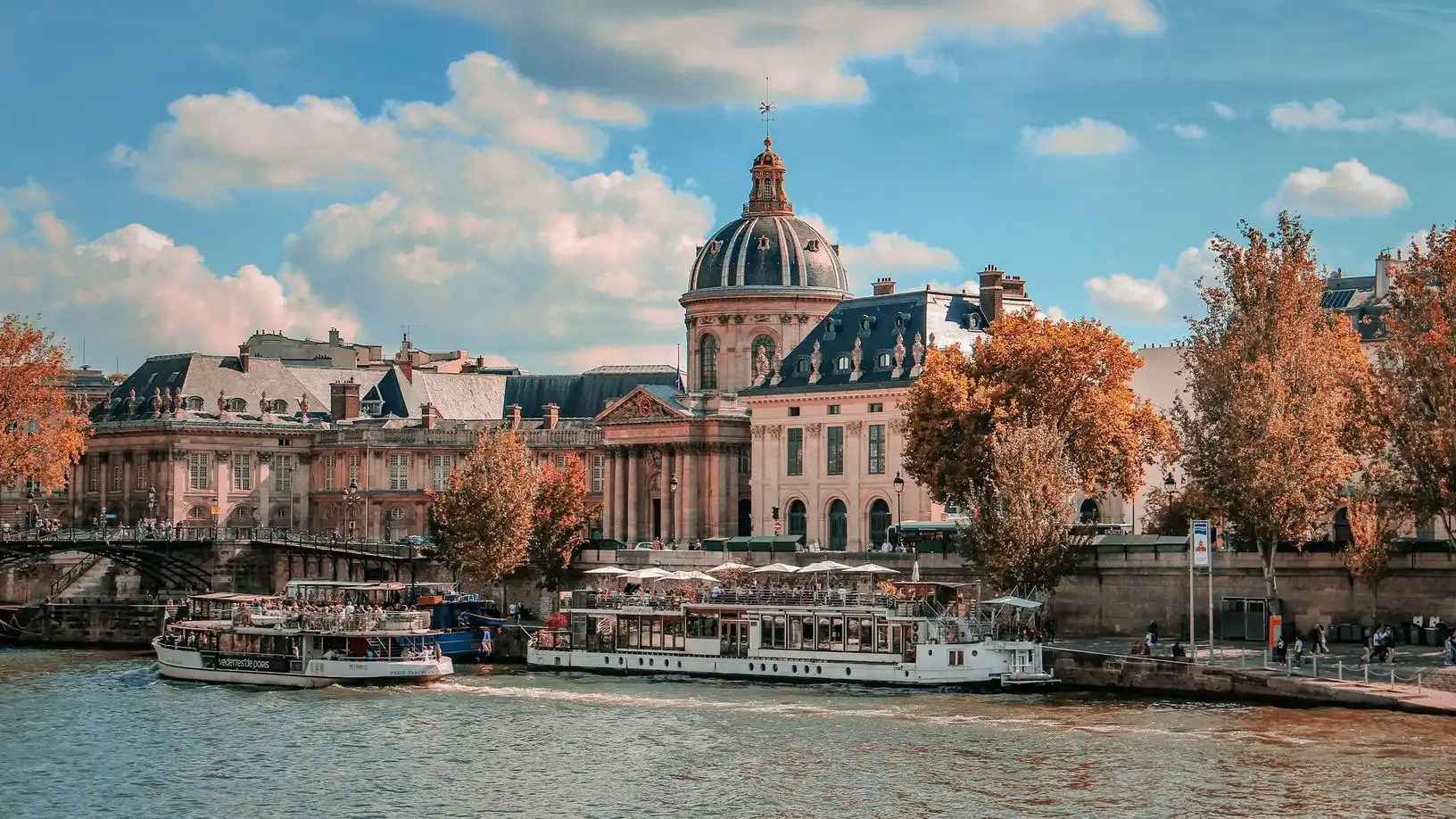 River boats moored on the Seine below the dome of the Institut de France